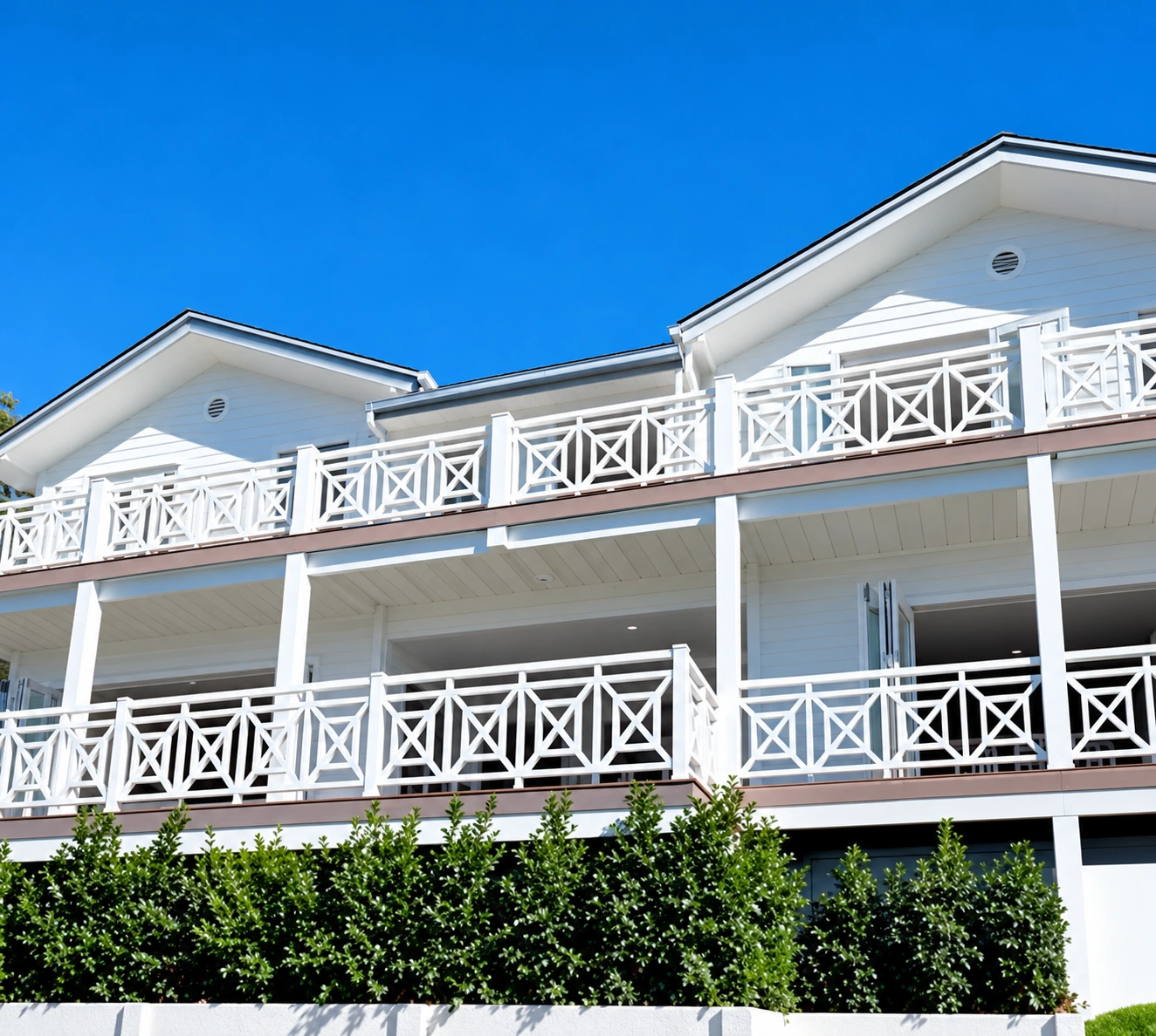 White cross-braced two-storey verandah; restored photograph